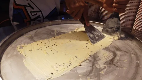 Make ice cream roll in the street. Stock Footage 105804939