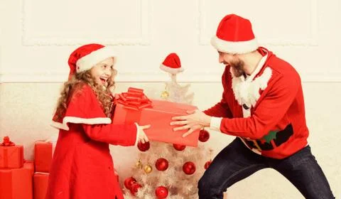 Make it fun. Kid cute girl play with father near christmas tree. Playful Stock Photos