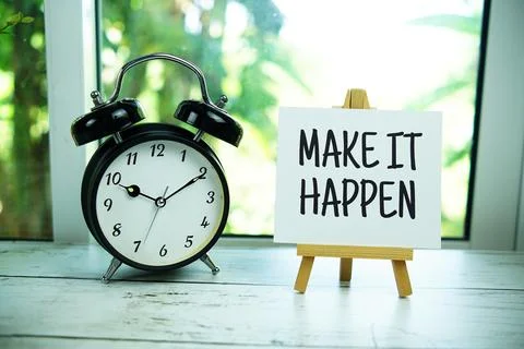 Make It Happen quotes text on paper card with easel and alarm clock in the .. Stock Photos