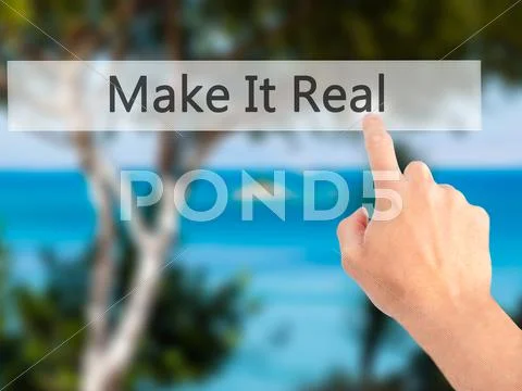 Make It Real - Hand pressing a button on blurred background concept . Busines Stock Photos