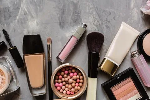 Make up items on gray concrete background. Set of luxury decorative cosmetics Stock Photos
