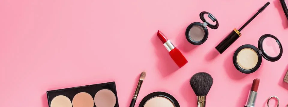 Make up items on pink color background. Horizontal web banner. Set of luxury  Stock-Fotos