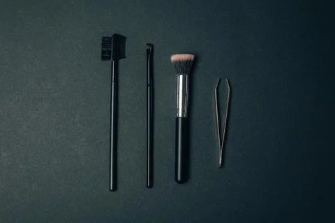 Make-up kit brushes and brow tweezer Stock Photos