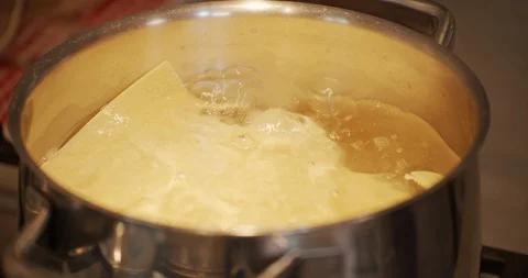 Make lasagna in the boiling pot Stock Footage 128926160