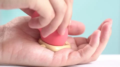 Make-up liquid beige foundation on beauty blender sponge, closeup. Foundati.. Stock Footage 277976503