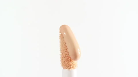 Make-up liquid beige foundation pouring on makeup brush, closeup. Cosmetic Stock Footage 167893104