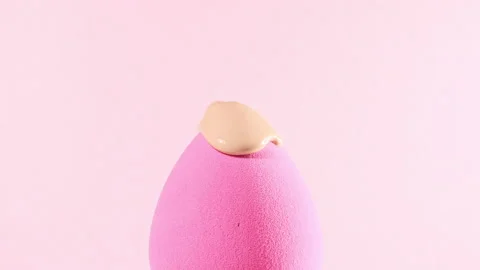 Make-up liquid beige foundation pouring on sponge, closeup. Cosmetic Dripping bb Stock Footage 169396181