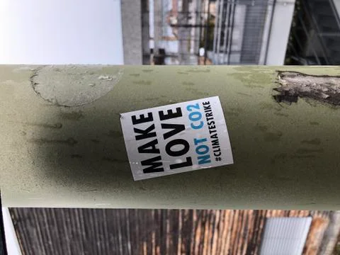 Make Love not CO2 sticker on street lantern in Switzerland. Stock Photos