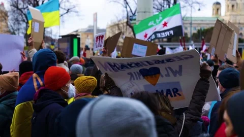 Make love, not war poster at a protest in Vienna, Austria Stock Footage 171127922