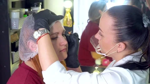 Make up master makes pencil marks before procedure of permanent makeup. Stock Footage 167666692