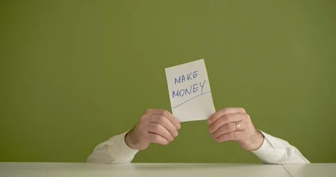Make Money - The man's mini picks up a sheet where it is written Stock Footage 267090282