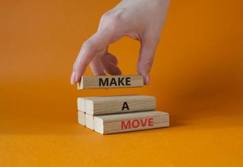 Make a Move symbol. Concept words Make a Move on wooden blocks. Businessman.. Stock Photos