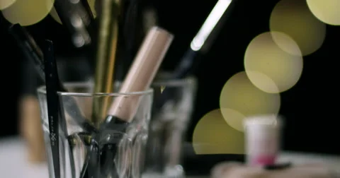 Make up objects and hand putting back pen in a glass. Stock-Footage 68788665