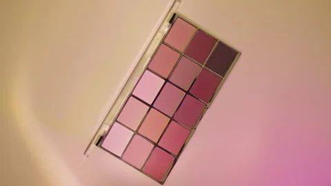 Make-up palette floating over a beige background Stock Footage 303161615