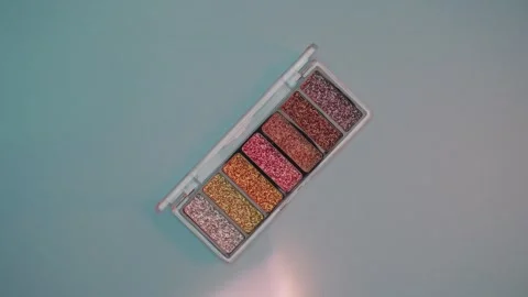 Make-up palette floating over a blue background Video stock 303161460