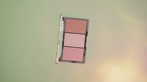Make-up palette floating over a green background Stock Footage 303161224