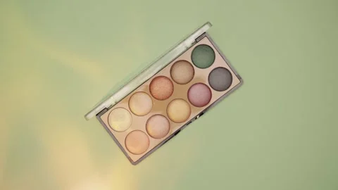 Make-up palette floating over a green background Stock Footage 303161243