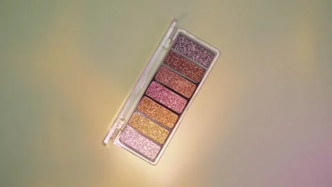 Make-up palette floating over a green background Stock Footage 303161348