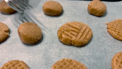 Make a pattern on homemade cookies with a fork. Stock Footage 234289712
