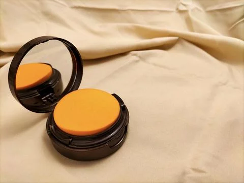 Make up powder on fabric background Stock Photos