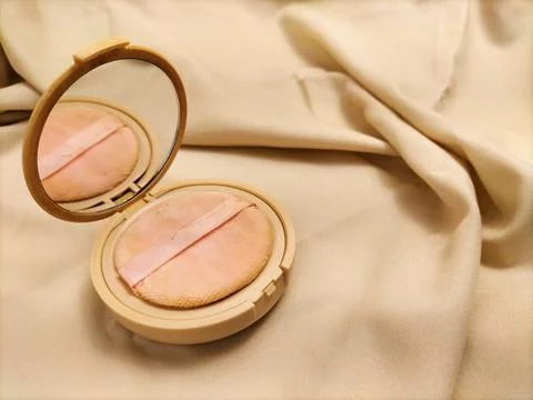 Make up powder on fabric background Stock Photos