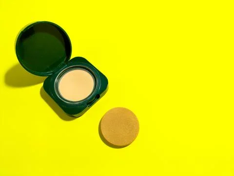 Make up powder on yellow background Stock Photos