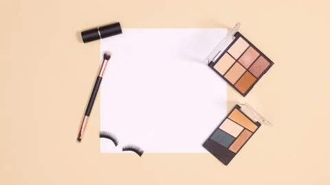 Make up products and blinking eye lashes move around paper. Stop motion Stock-Footage 150750031