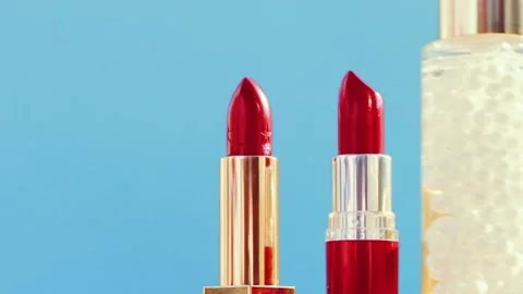 Make-up products on blue background, set of skincare, perfume and lipsticks Stock-Footage 136110533