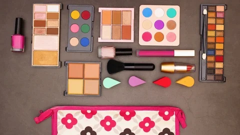 Make up products come out of cosmetics bag and line up on the table -Stop motion 動画素材 123096599
