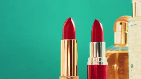 Make-up products on green background, set of skincare, perfume and lipsticks Stock-Footage 141742381