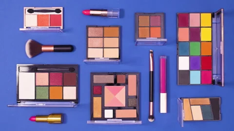 Make up products make pattern on dark blue background. Stop motion flat lay Stock Footage 153174620