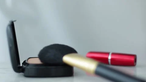 Make-up products on marble table, powder, lipstick and brush as background for Stock Footage 135129259
