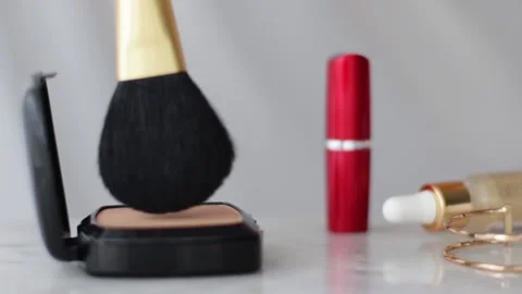 Make-up products on marble table, powder, lipstick and brush as background for Stock Footage 135134924