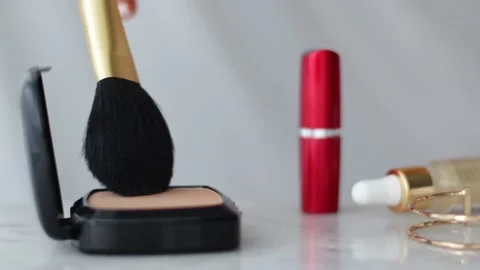 Make-up products on marble table, powder, lipstick and brush as background for Stock Footage 139351466