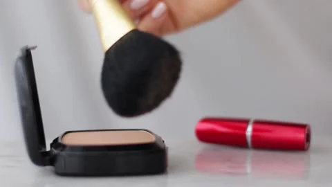 Make-up products on marble table, powder, lipstick and brush as background for Stock Footage 139617588