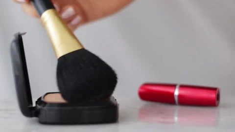 Make-up products on marble table, powder, lipstick and brush as background for Stock Footage 153922928