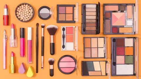 Make up products pattern on orange background. Flat lay Stock Photos