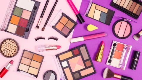 Make up products pattern on pink and purple background. Flat lay Stock Photos
