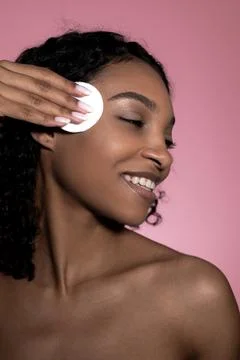Make up removal concept vertical banner. Smiling girl using cotton pad Stock Photos
