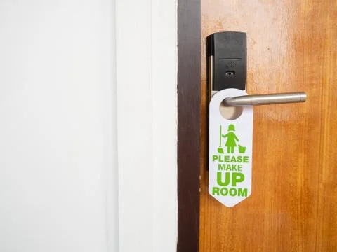 Make up room sign attached to the front of the room that is closed inside the Stock Photos