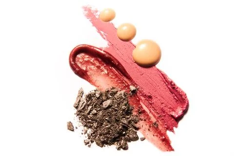 Make up samples of foundation, lipstick and eye shadow. Stock Photos