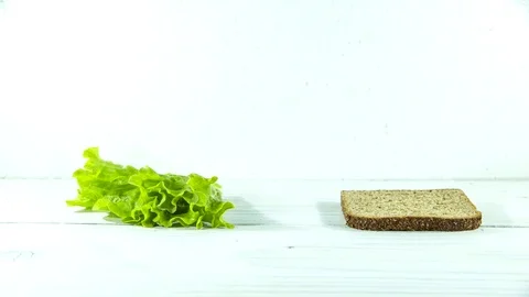 Make sandwich, bread, sausage, ham, lettuce, sauce, tomato. Time lapse. Close up Stock Footage 123166510