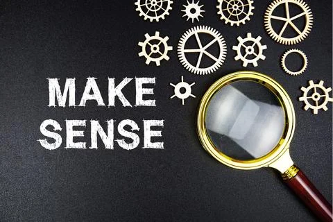 Make Sense text message with magnifying glass on black background Stock Photos