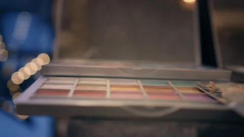 Make-up set of eyeshadows, foundations and beauty sponge on the table. Closeup. Stock Footage 86715320