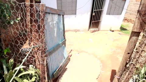 A make shift fence and gate in front of a house Video stock 256991851