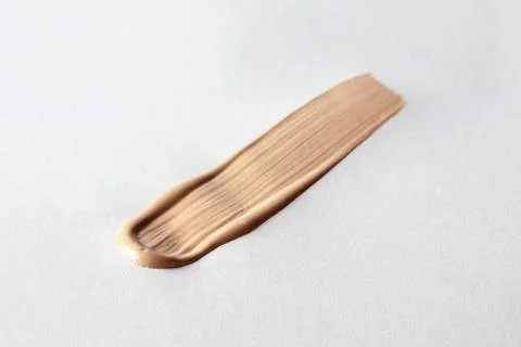 Make up smear foundation smudge texture. Liquid foundation swatch close up Stock Photos