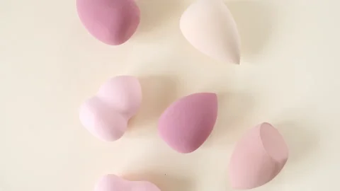 Make-up sponges, makeup brush on beige background. Makeup products. The beauty Stock Footage 197978690