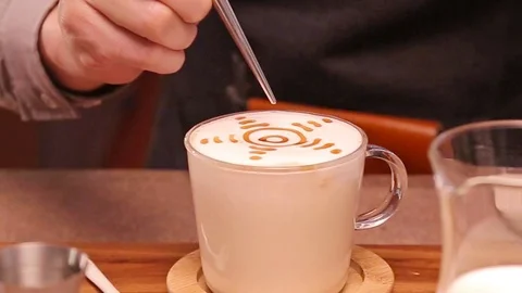 Make a Sun Pattern on a Tea Latte Stock Footage 121714997