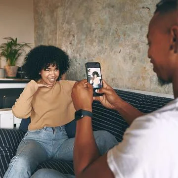 Make sure to snap a few from every angle. a young woman posing while her Stock Photos