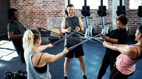 Make sure you get the right type of motivation. a fitness group working out with Stock Photos